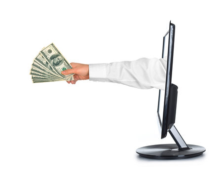 Hand with money and computer monitor