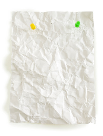 crumpled page and color pushpins isolated in whiteの写真素材
