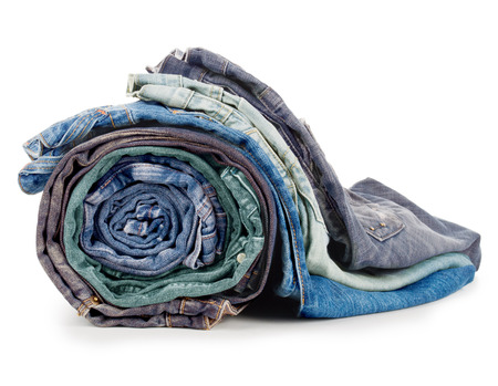stack of various jeans isolated on white backgroundの写真素材