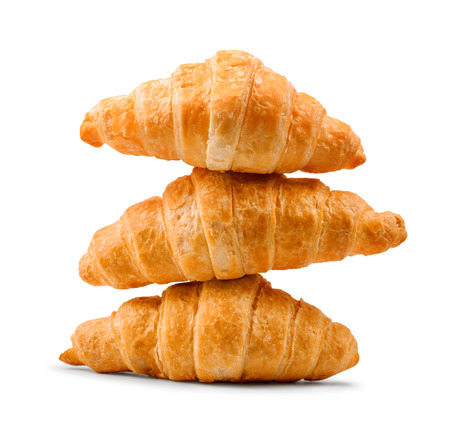 pile of fresh and delicious croissants on a white backgroundの写真素材
