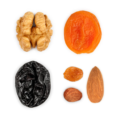 Collection of dried fruits: walnuts, dried apricots, prunes, raisins, hazelnuts, almonds