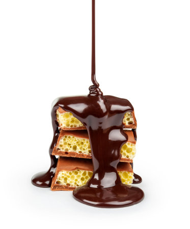 Slices of milk and dark chocolate bar poured chocolate isolated on whiteの写真素材