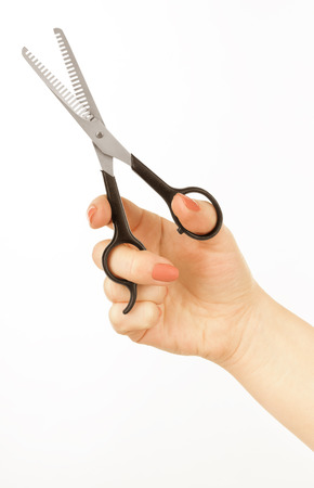 hairbrush in the hand isolated on whiteの写真素材