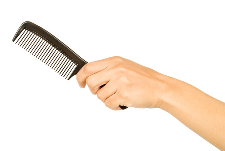 hairbrush in the hand isolated on whiteの写真素材