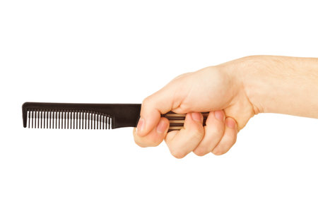 hairbrush in the hand isolated on whiteの写真素材