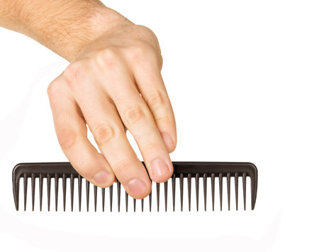 hairbrush in the hand isolated on white