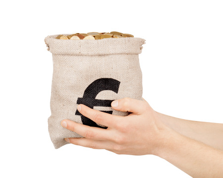 hand holds bag with coinsの写真素材