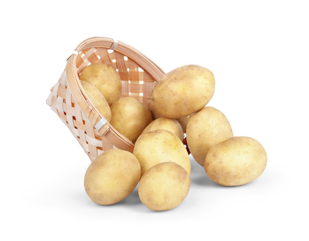 Fresh new potatoes picked in rustic basket isolated on white backgroundの写真素材