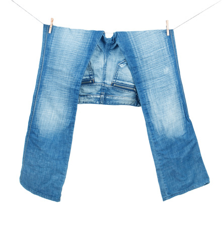 Blue jeans on washing line isolated on whiteの写真素材