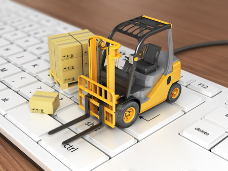 Concept of delivering, shipping or logistics. Forklift on keyboard.の写真素材