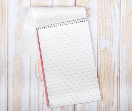 blank realistic spiral Notepad on wooden background