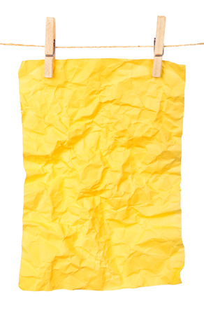 yellow paper-a poster on clothespinsの写真素材