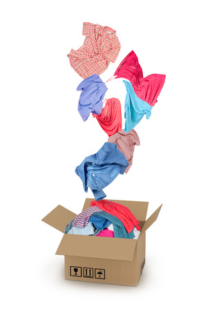 Clothes falling into the cardboard box on whiteの写真素材