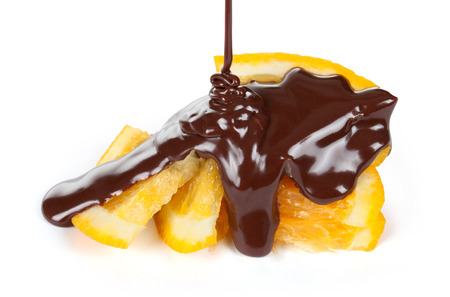 slices of orange with pouring chocolateの写真素材
