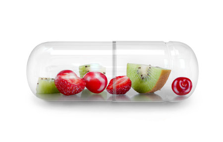 Medical Capsule With Berries Within And Falling Berries Isolated On White