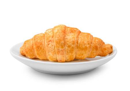 delicious fresh croissant on a white plate isolated on white backgroundの写真素材