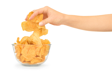 Hand with potato chips and bowl on white backgroundの写真素材