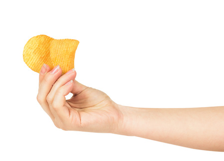the hand holds a couple of potato chips isolated on white backgroundの写真素材