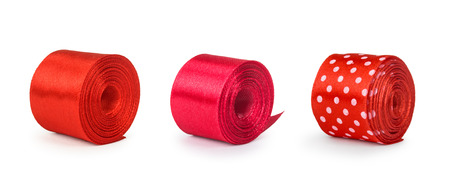 a collection of rolls of red ribbon isolated on white backgroundの写真素材