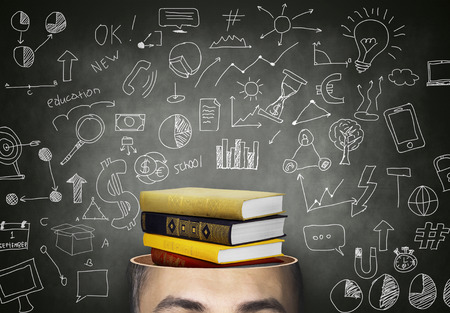 Male head with stack of books - educationの写真素材