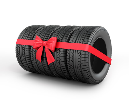 A set of rubber tires with ribbon and bow.の写真素材