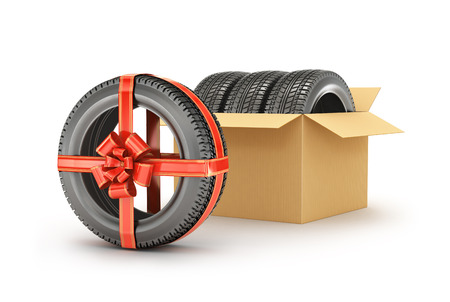 Concept tire gift or discount. Three tires in an open cardboard box on a white background isolationの写真素材