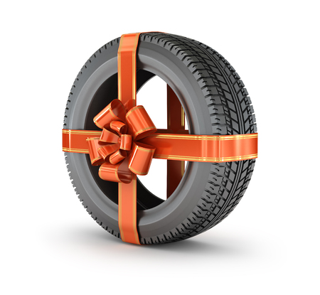 Gift tire is wrapped with a ribbon bow, isolated on a white backgroundの写真素材