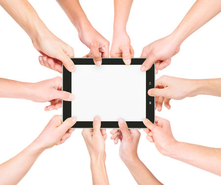 many hands holding a tablet on a white