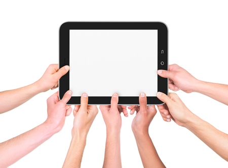 many hands holding a tablet on a whiteの写真素材