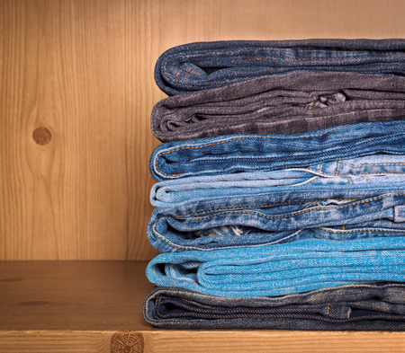 Jeans on a wooden shelfの写真素材