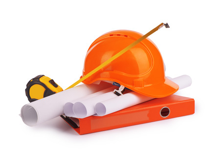 Rolled drafts with a construction helmet.の写真素材