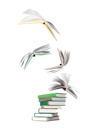 stack of books and flying books isolated on whiteの写真素材