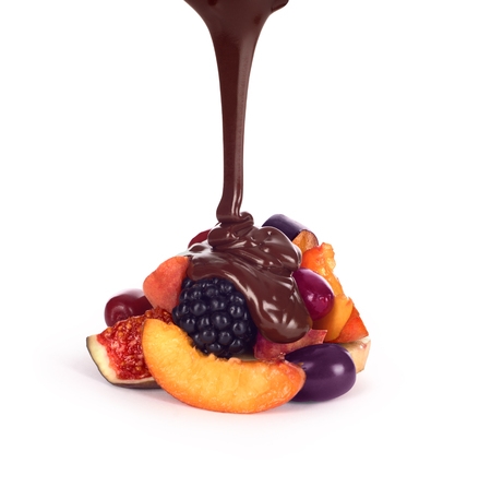 assorted fruits and chocolate sauce pouring still life isolated over white backgroundの写真素材