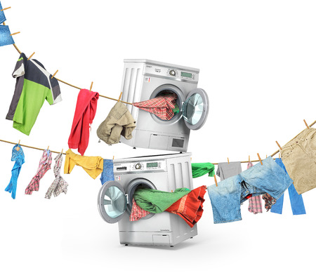 The big washing concept. Clothing on the ropes rushes from the washing machine and dryer isolated on a white backgroundの写真素材
