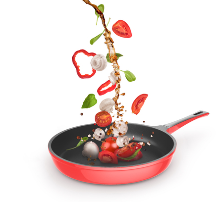 Frying pan with vegetables on a white backgroundの写真素材