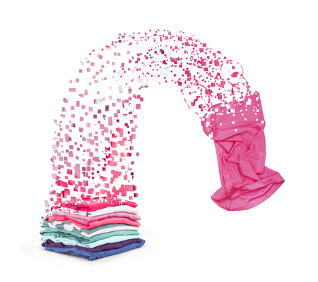A colorful stack of clothes that are falling apart on a piece on a white background.の写真素材