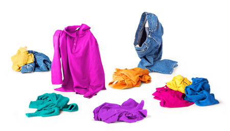 Bright clothes fall to the floor on a white backgroundの写真素材