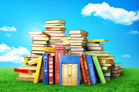 Concept of education. Stack of books with door on a natural background. Concept of knowledge.の写真素材
