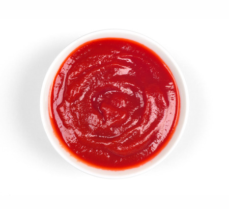 Bowl of ketchup or tomato sauce on white background, top viewの写真素材