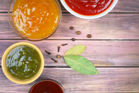 bowls with sauces on a wooden background, top viewの写真素材