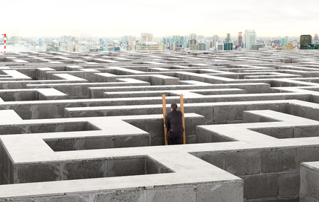Image of a businessman standing on the stairs in a labyrinth. 3d illustrationの写真素材