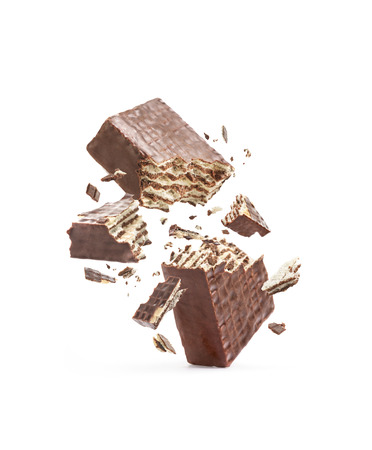 Chocolate waffles are broken in half, isolated on a white backgroundの写真素材