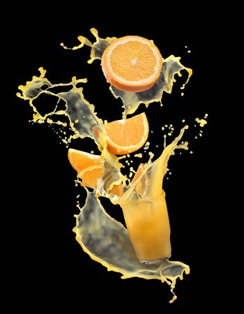 Beautiful splash of orange juice with oranges. Orange juice on a black backgroundの写真素材