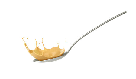 mustard splash in spoon on white backgroundの写真素材