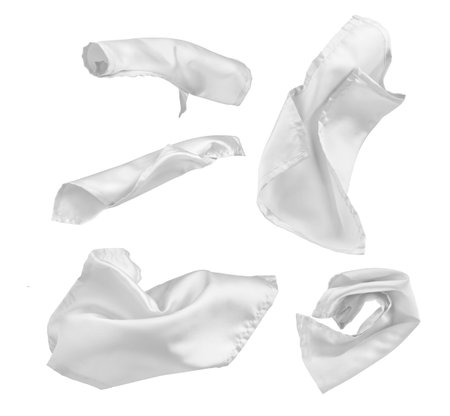 set of white flying pieces of fabric on a white backgroundの写真素材