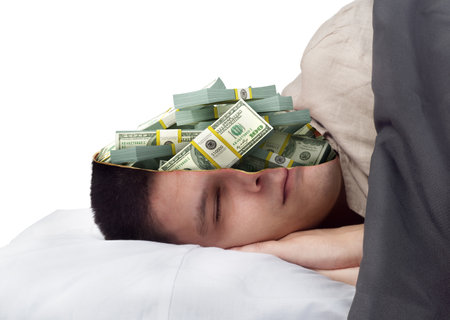 Young handsome sleeping man with a cut on his head holding a pile of cashの写真素材