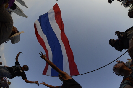 Thai anti-government protesters wave national flags falling on a rally at theDemocracy Monument in Bangkok, Thailand, Saturday January 11, 2014のeditorial素材
