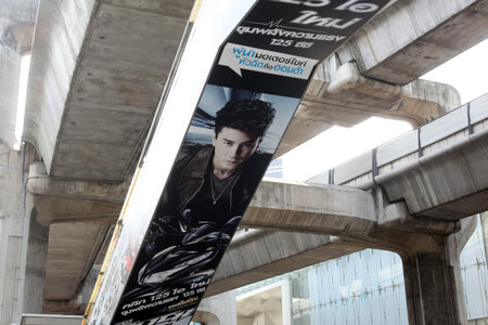 An advertisement under the Skytrain bridge around the Siam Square district in the center of capital Bangkok in Thailandのeditorial素材