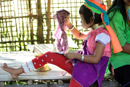 A traditionally dressed wife of a long-necked Paudang tribe from Burma living in a village north of Chiang Mai in northern Thailandのeditorial素材