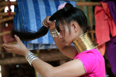 A traditionally dressed wife of a long-necked Paudang tribe from Burma living in a village north of Chiang Mai in northern Thailandのeditorial素材